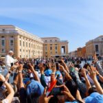 crowd of people gathered in front of a cathedral