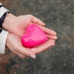 Close Up Shot of a Person Holding a Toy Heart
