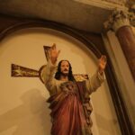 Low Angle Shot of Christ Figurine and Cross in a Church