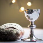 gray stainless steel chalice and bread bun