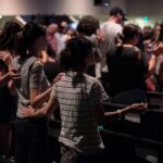 a group of people standing in front of a crowd of people