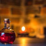 A mystical potion bottle glows warmly in candlelight against a rustic brick background.