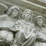 a close up of a statue of angels on a building