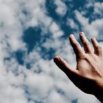 person hand reaching for the sky