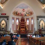 a church filled with lots of people sitting down