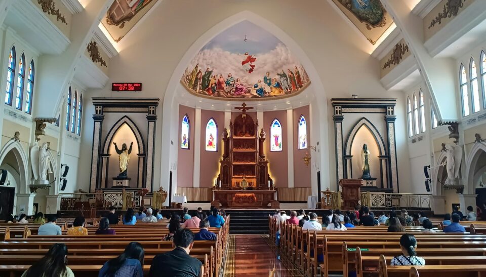 a church filled with lots of people sitting down