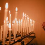 man standing near lighted candles