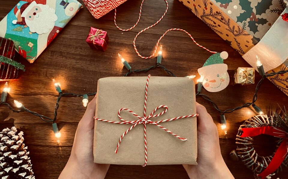 person holding brown box