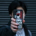 a man taking a picture of himself with his cell phone