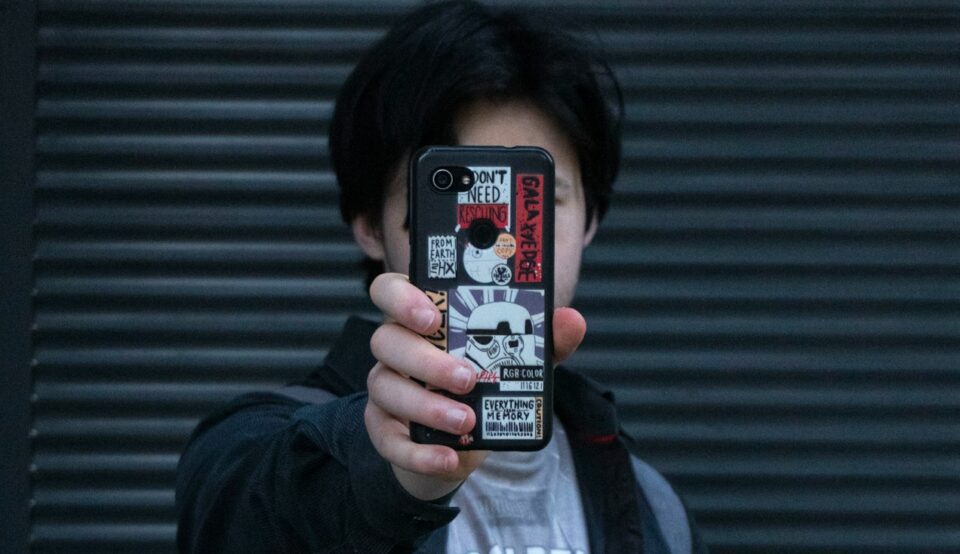 a man taking a picture of himself with his cell phone