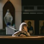 a woman sitting on the floor in a church