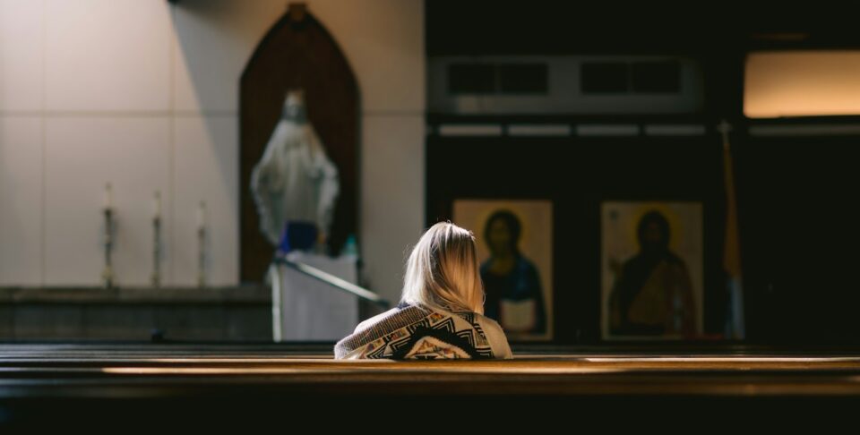 a woman sitting on the floor in a church