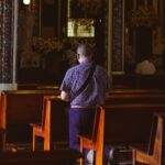 a man sitting in a chair in a church