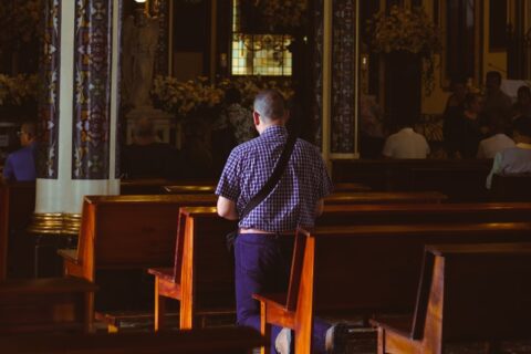 a man sitting in a chair in a church