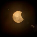 Captured partial solar eclipse set against a deep dark sky, perfect for astronomy enthusiasts.