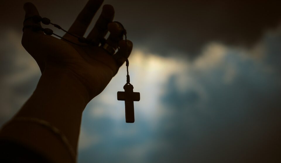 person holding rosary