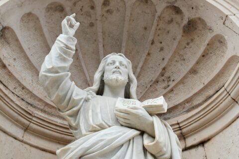 a statue of a person holding a book