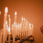 man standing near lighted candles