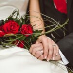 man holding red flowers