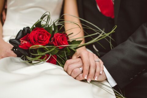 man holding red flowers