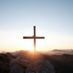 brown cross on brown rock during daytime