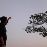 a man is flying a kite in the sky