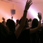 people raising their hands in front of people raising their hands