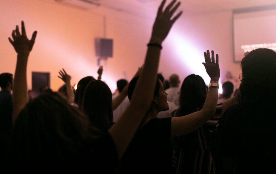 people raising their hands in front of people raising their hands