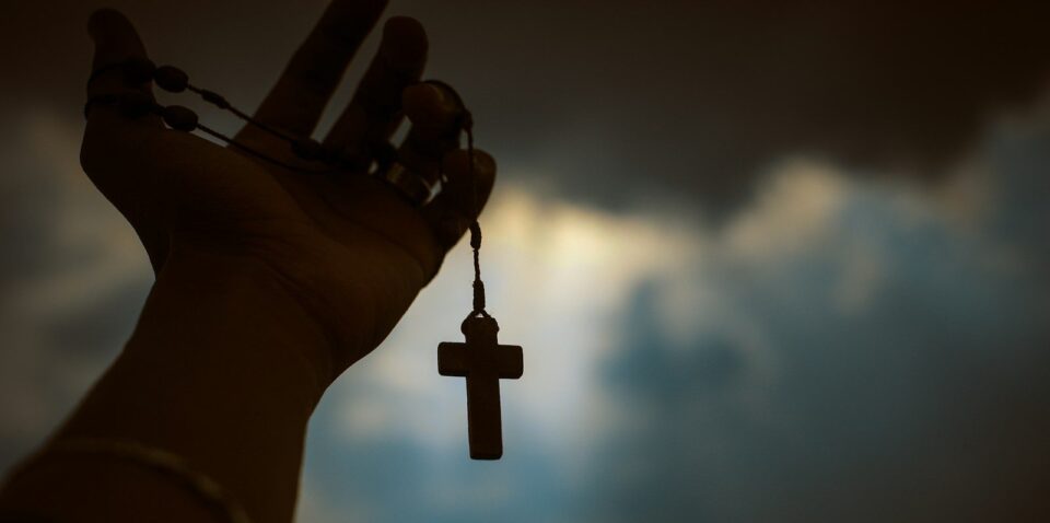 person holding rosary