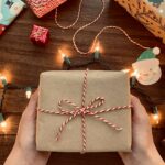 person holding brown box