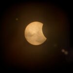Captured partial solar eclipse set against a deep dark sky, perfect for astronomy enthusiasts.