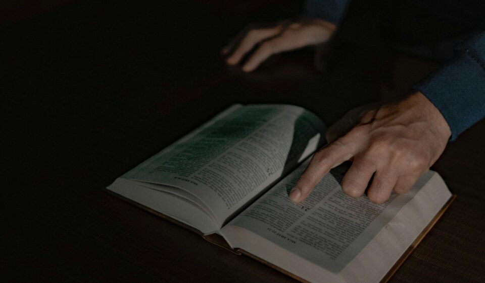 a person touching a book with their hand