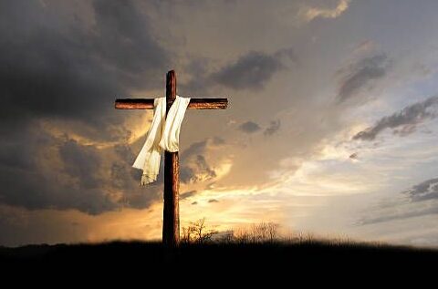 Križ na brdu u zalasku sunca kao simbol Kristove žrtve i nade uskrsnuća