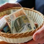 a person holding a basket full of money