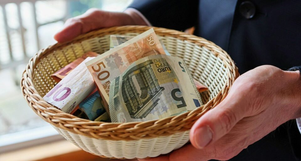 a person holding a basket full of money