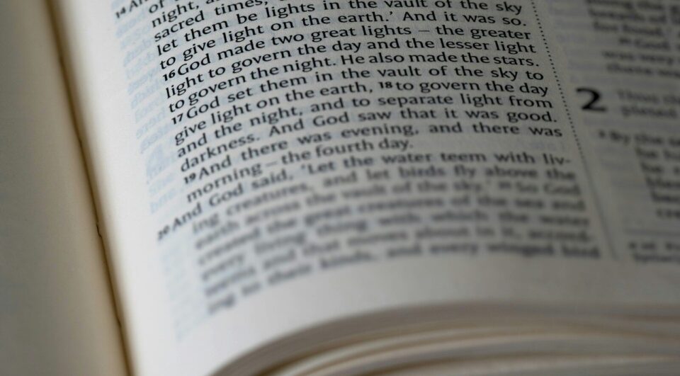 A bible is open to a passage of text.