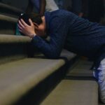 man kneeling on stair