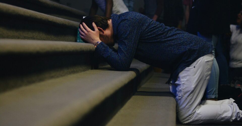 man kneeling on stair