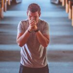 man standing near altar praying