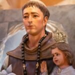 a statue of a man and a little girl standing next to each other