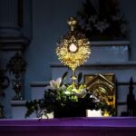 a church altar with lit candles in front of it