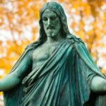 statue of a woman with a background of trees