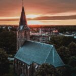 a church steeple with a sunset in the background