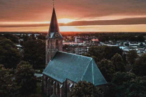 a church steeple with a sunset in the background