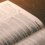 An open book lies on a wooden surface.