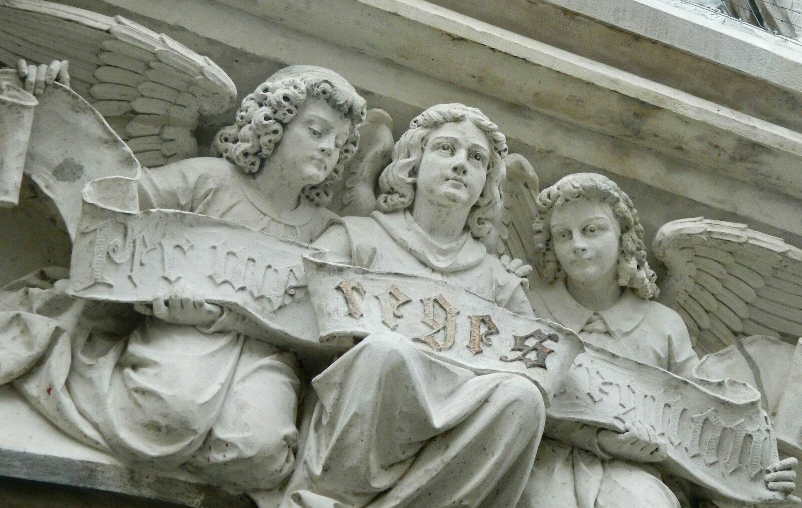 a close up of a statue of angels on a building