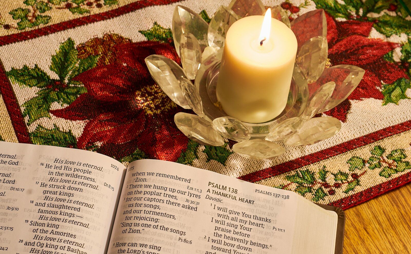 white pillar candle on clear glass holder
