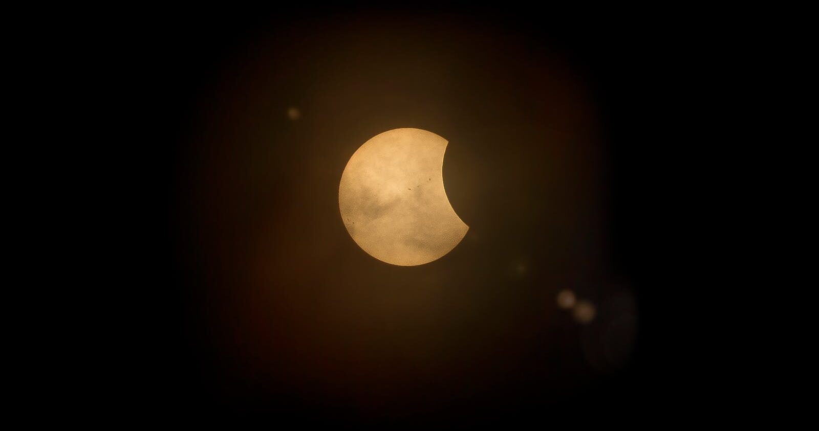Captured partial solar eclipse set against a deep dark sky, perfect for astronomy enthusiasts.