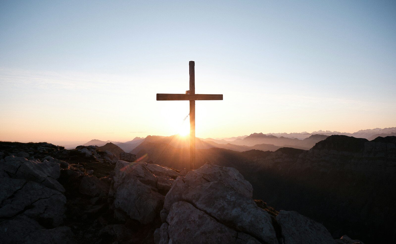 brown cross on brown rock during daytime