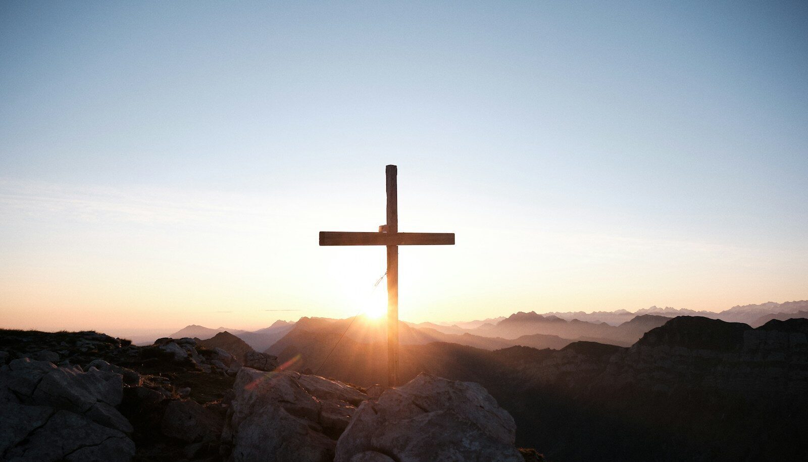 brown cross on brown rock during daytime